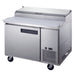 a stainless steel counter with two doors and two drawers